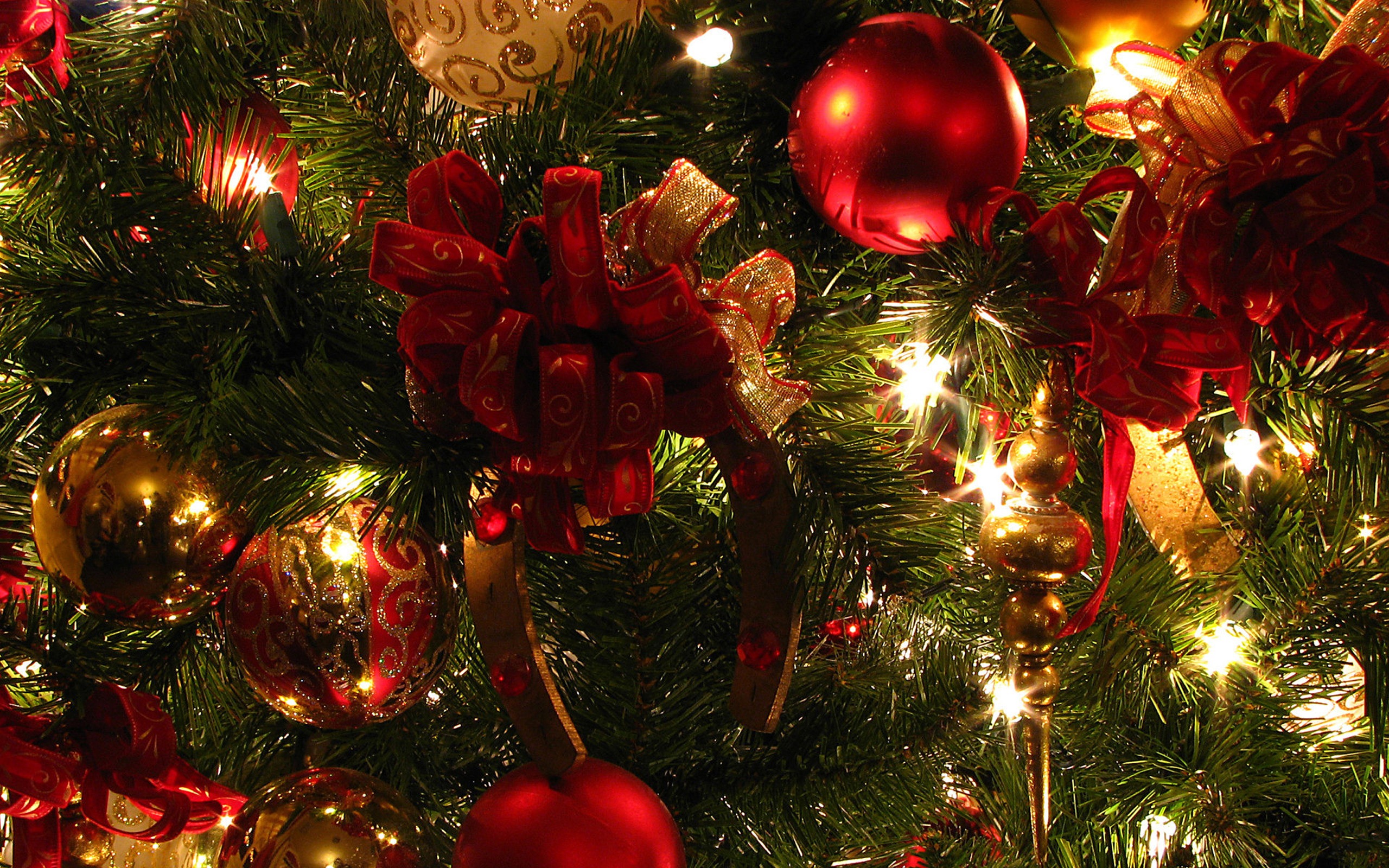 Close-up of a decorated Christmas tree with ornaments, ribbons, and lights