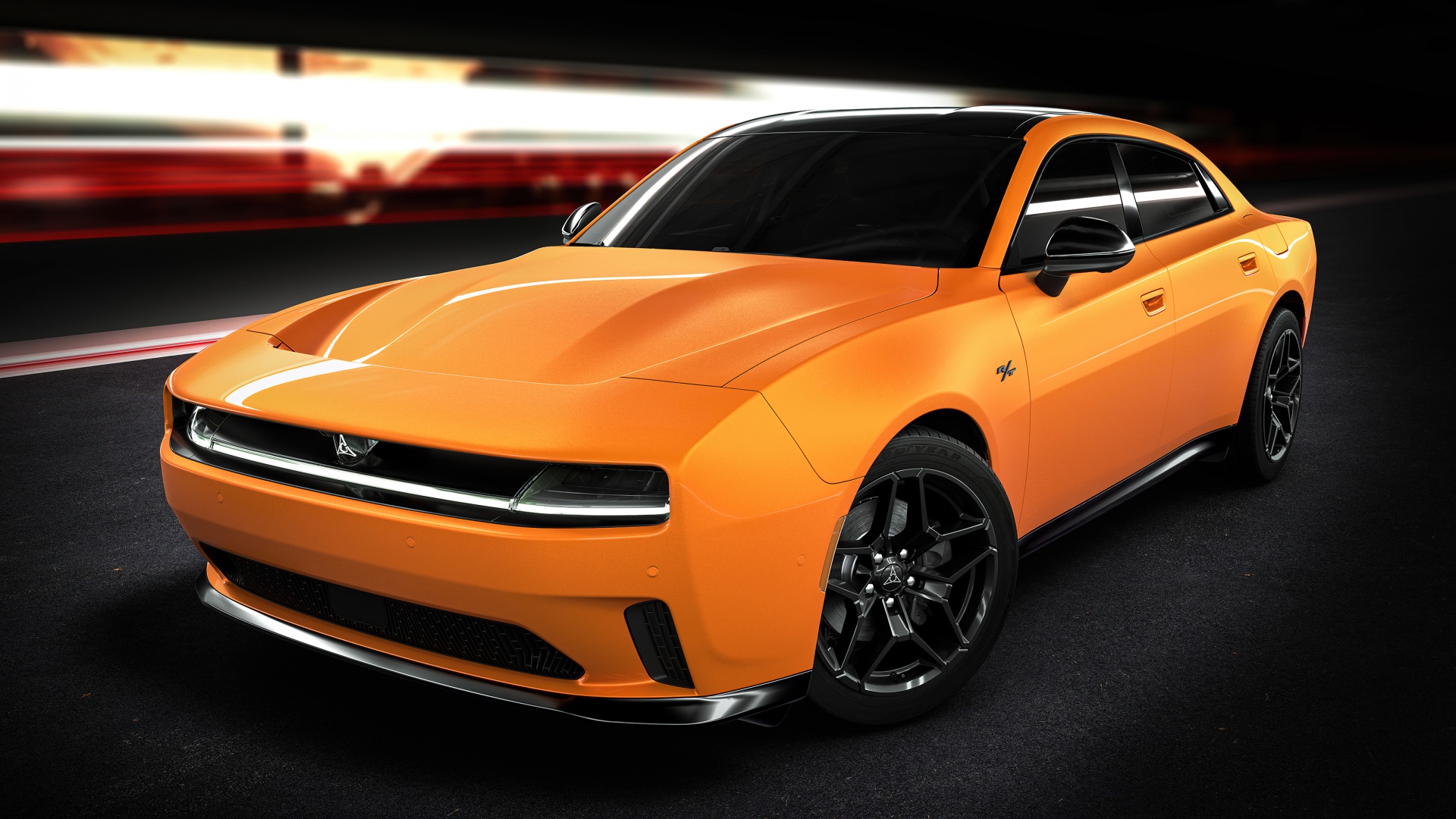 A vibrant orange Dodge Charger Daytona SRT Banshee, a fully electric muscle car, is showcased in a dimly lit setting, possibly on a race track, highlighting its modern and powerful design