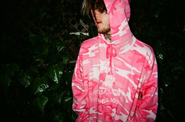 A wallpaper with a man wearing a pink jacket. 