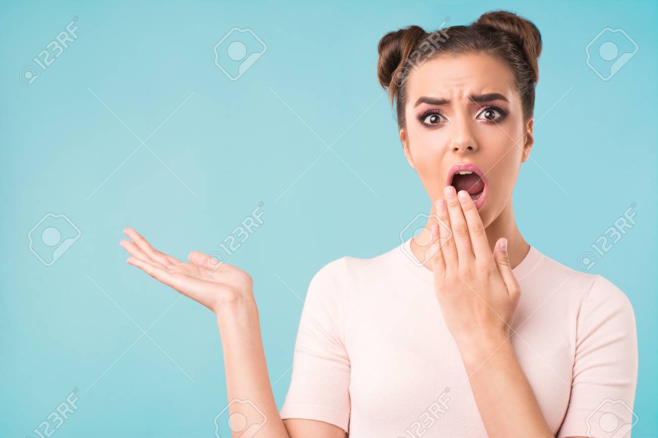 Girl With A Surprised Face On Blue Background Stock Photo