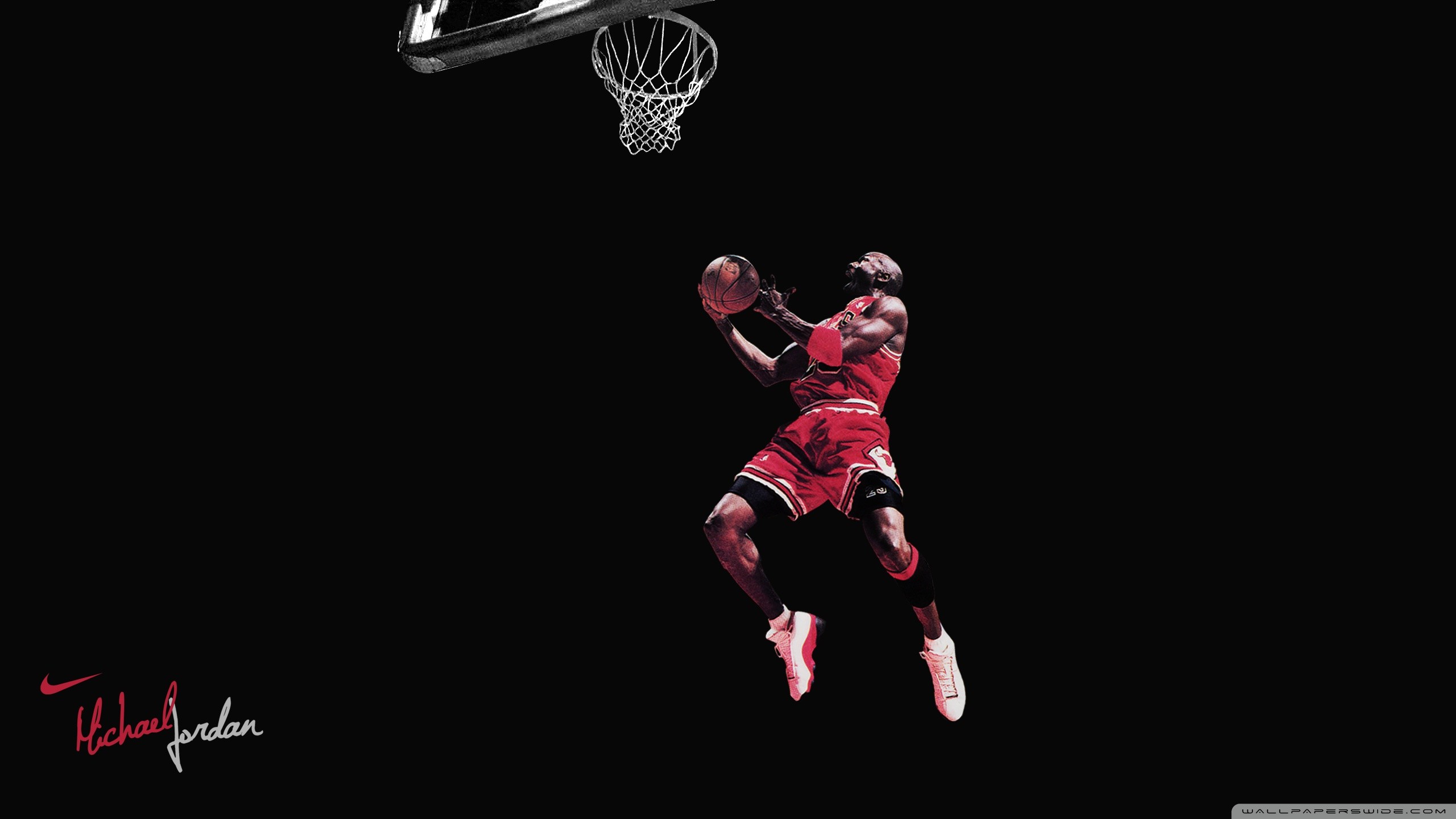 Michael Jordan performing a dunk in a Chicago Bulls uniform, set against a stark black background