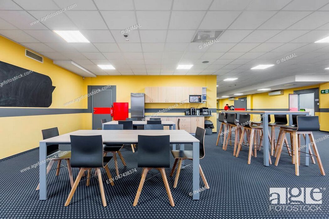 Modern Lunchroom Interior With Wooden Tables And Black Chairs