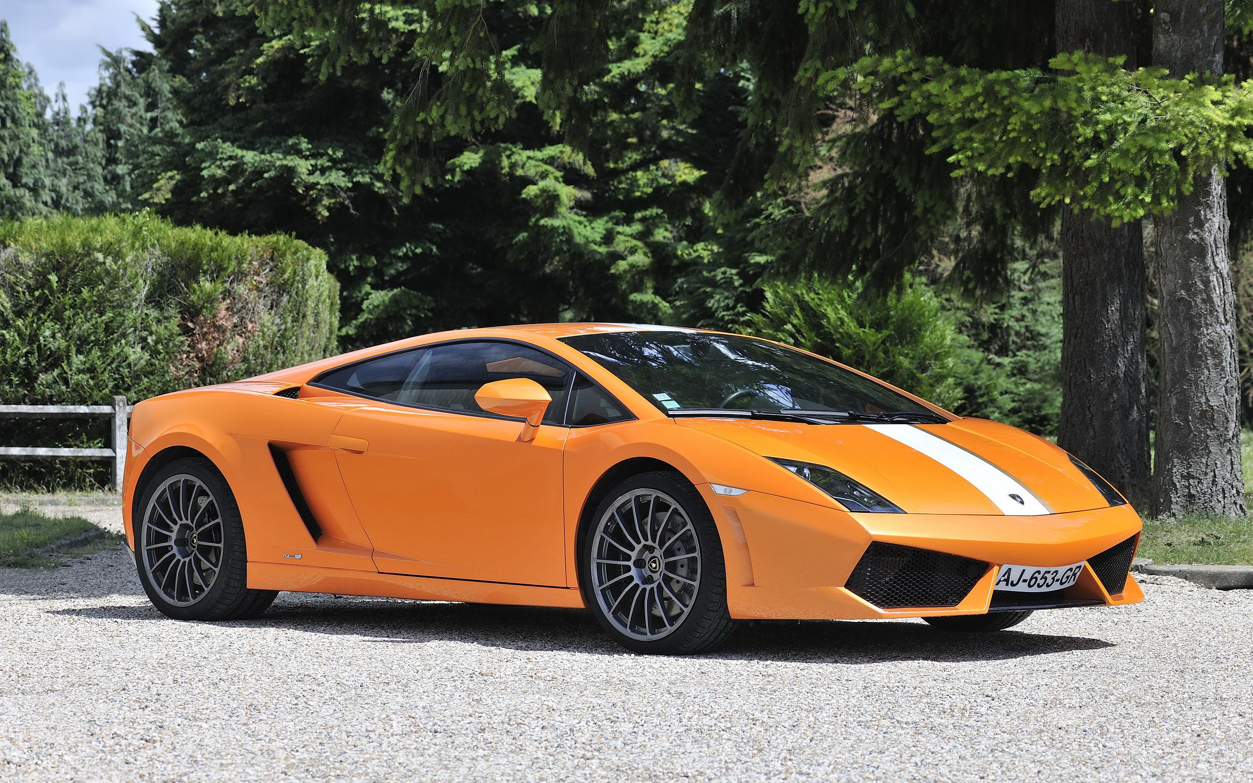 Orange Lamborghini Gallardo parked on a gravel driveway