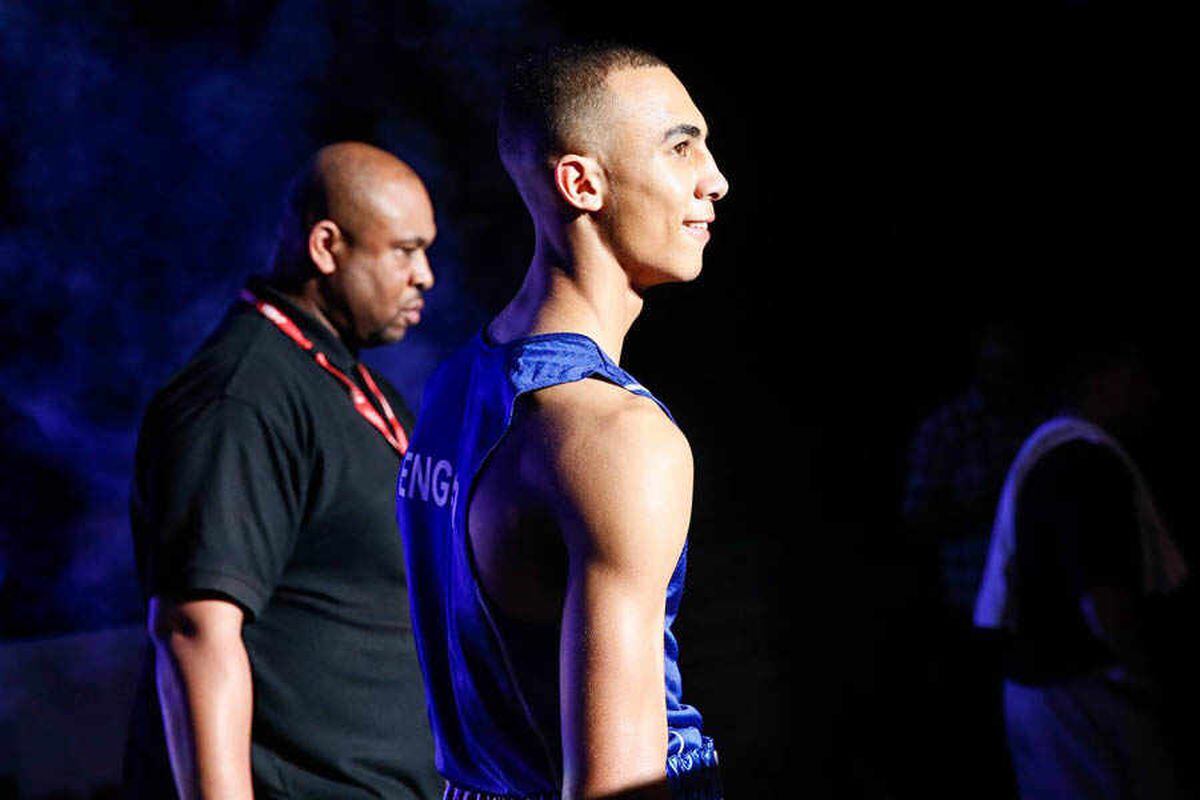 Benjamin Whittaker, the English boxer, stands in profile view, wearing his blue boxing vest, seemingly moments before a match