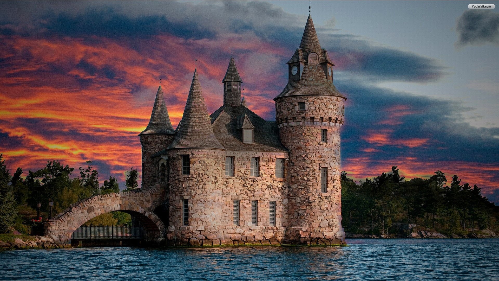 A majestic stone castle at sunset, surrounded by water, with a dramatic sky backdrop
