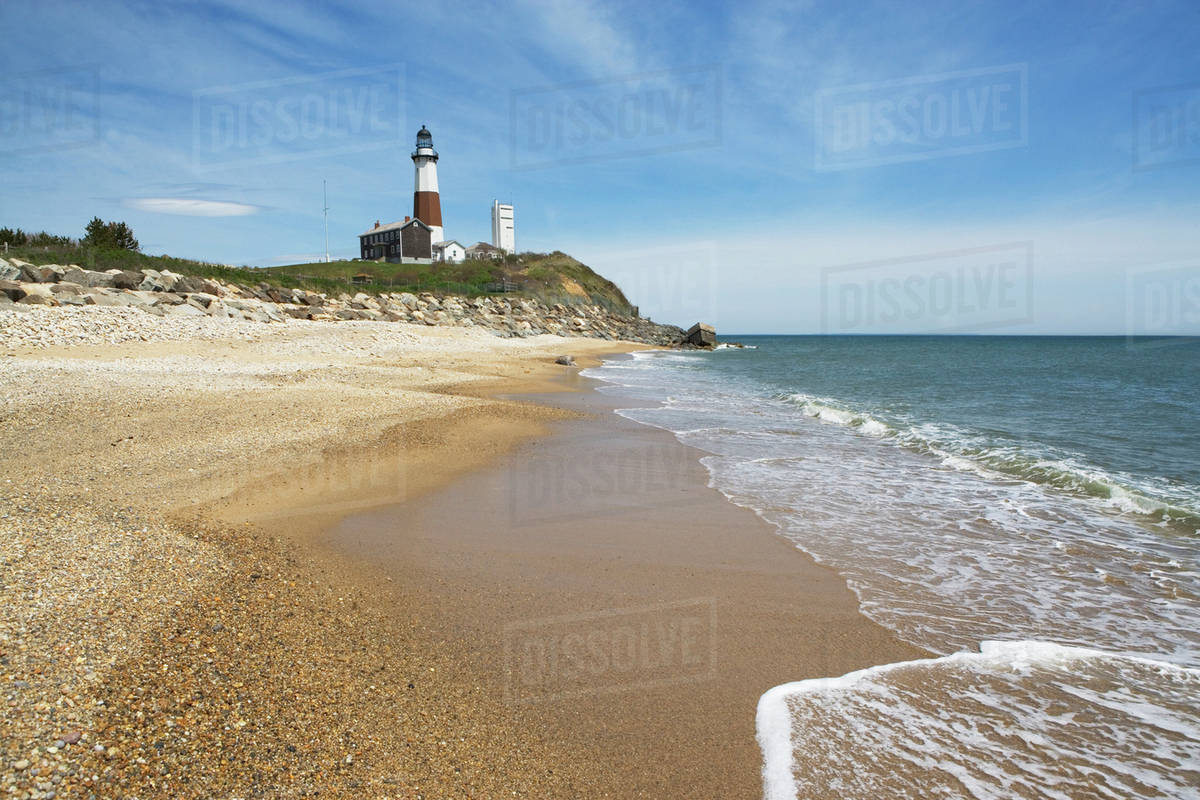 Beach With Lighthouse In Background Stock Photo Dissolve