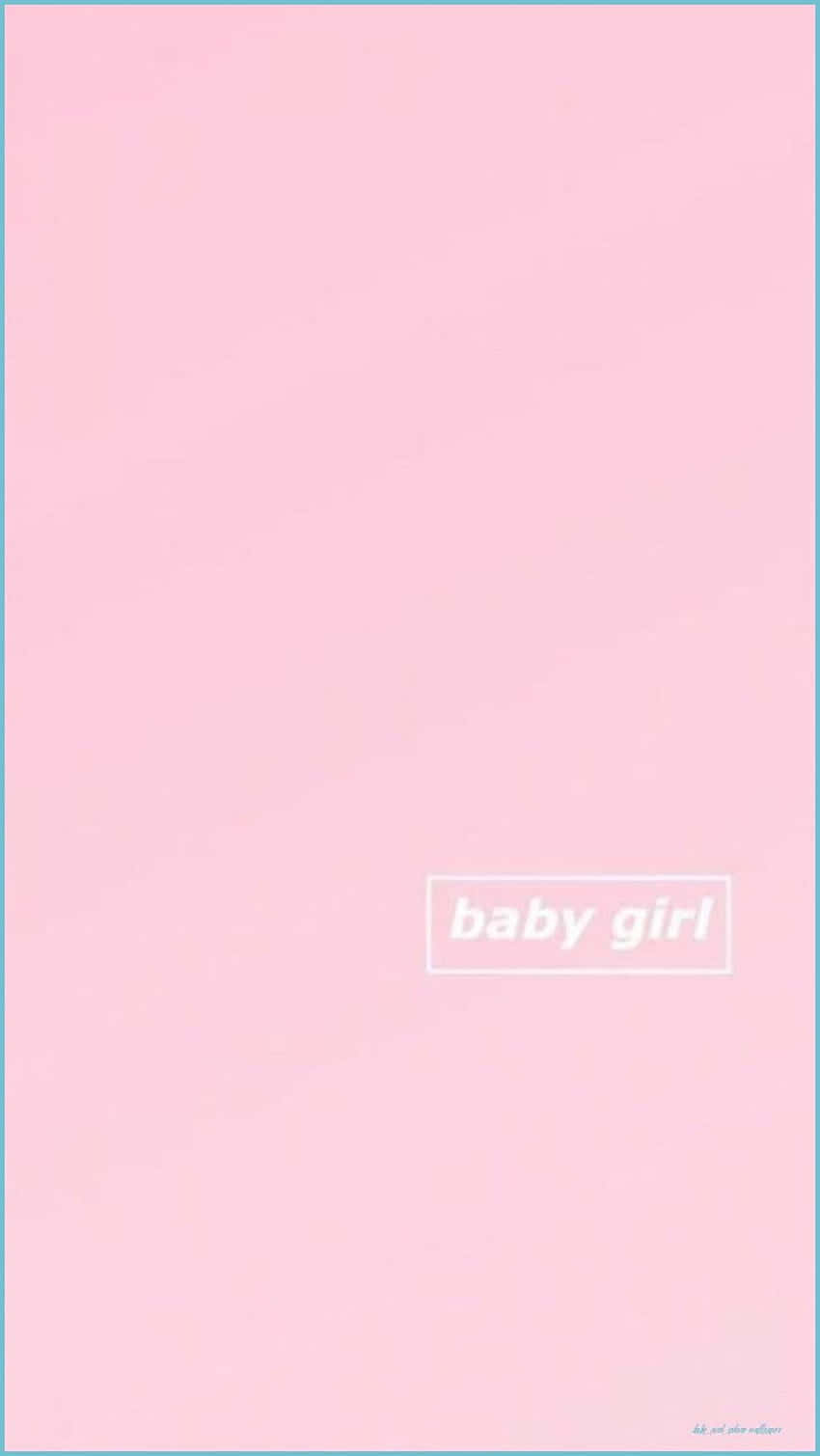 A Baby Girl Dressed In Pink Showing Off Her Sweet Smile Wallpaper