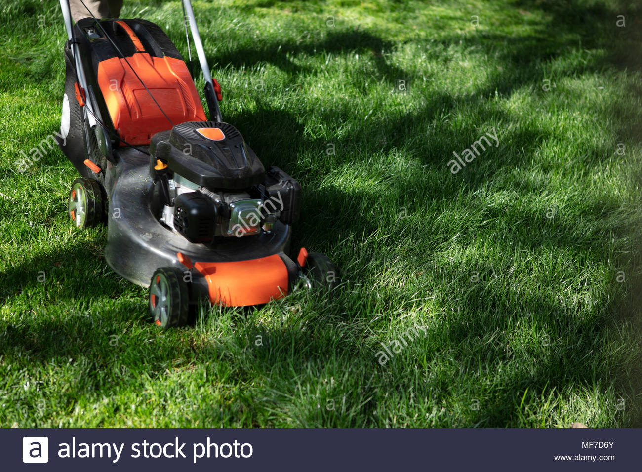 Orange Lawn Mower Cutting Grass Gardening Concept Background