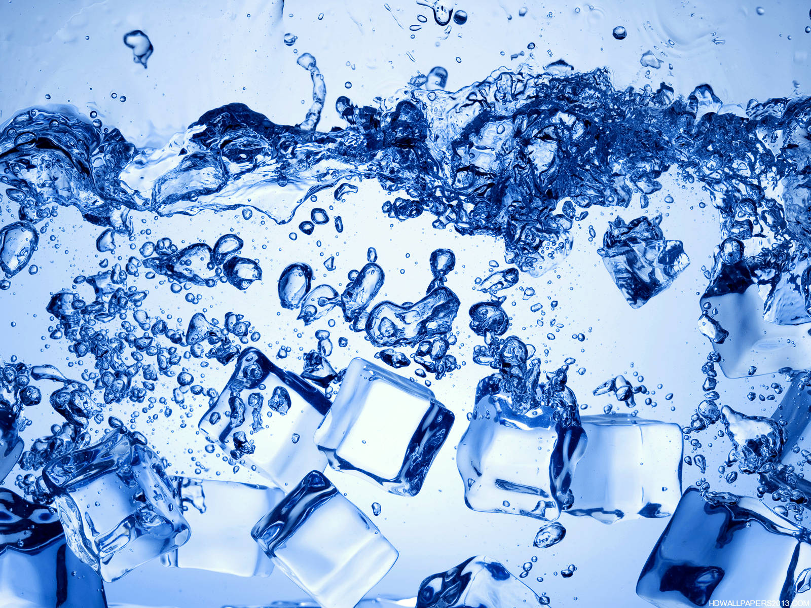 Close-up of ice cubes splashing in cool, refreshing water