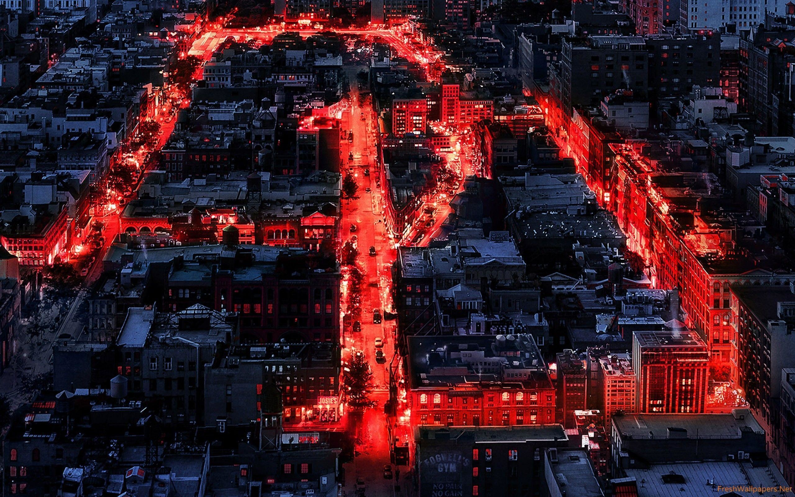 A stunning aerial view of Hell's Kitchen in New York City at night, illuminated by a bold red glow, possibly symbolizing Daredevil's presence. From Netflix's Daredevil series