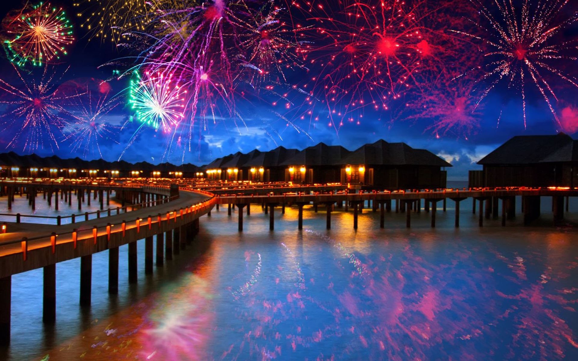 Fireworks exploding over a tropical resort at New Year's