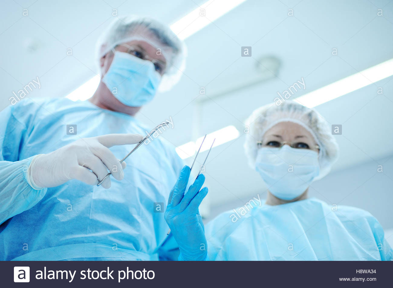 Surgeons Operate On A Patient In The Background Surgical Lamp