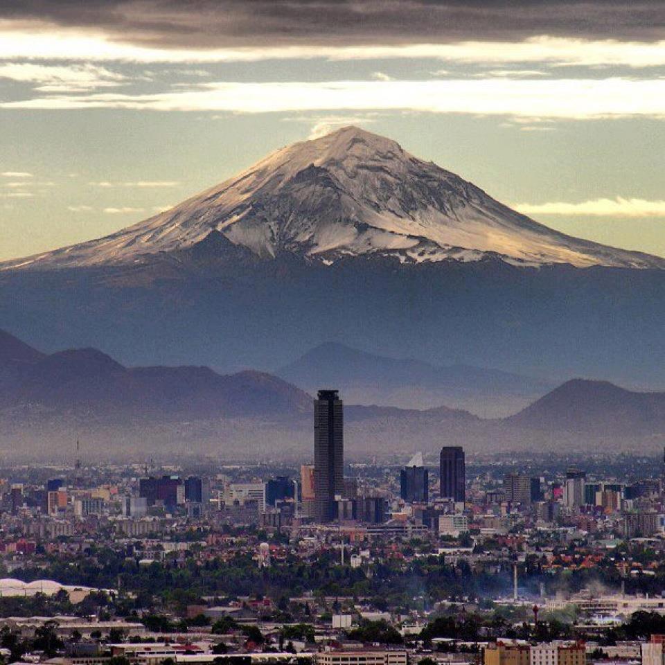 Mexico City With Popocatepetl On The Background