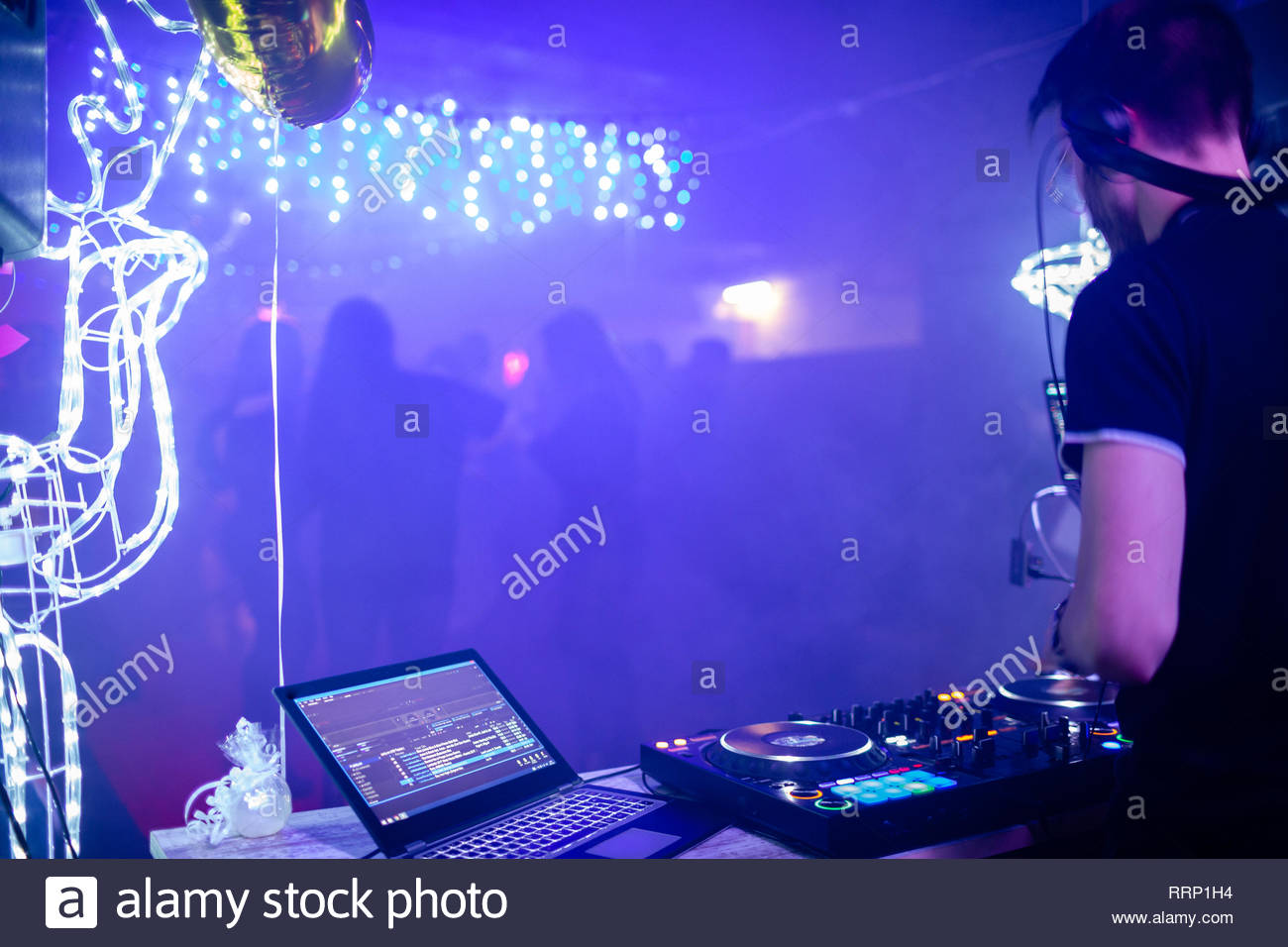 Dj At His Station With Dancefloor In The Background Stock Photo