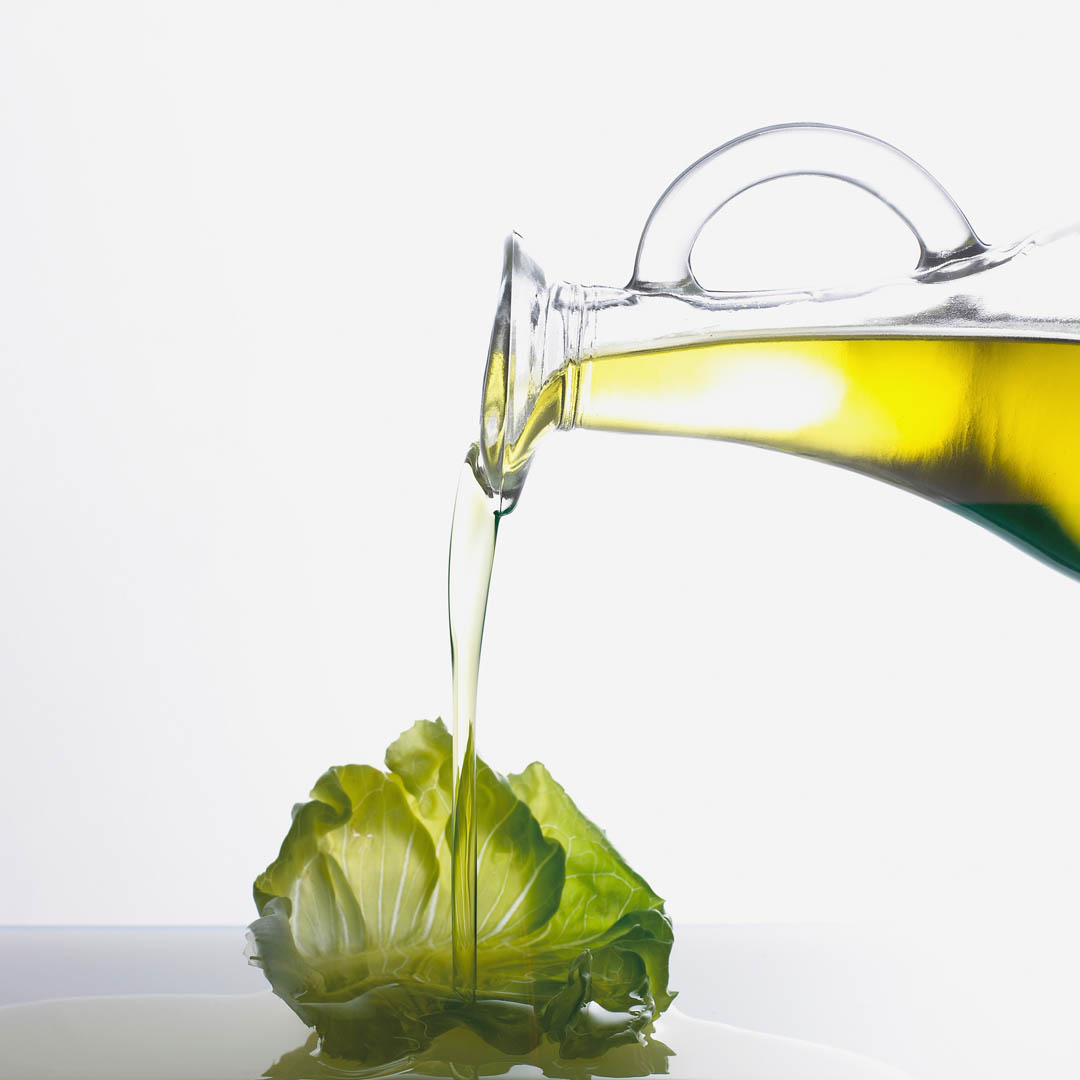 Oil Olive Pouring On Lettuce Leaf