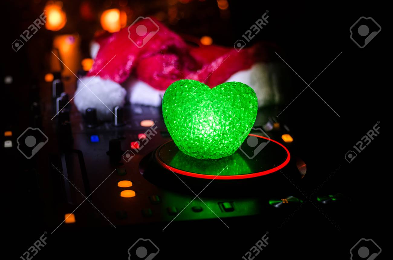 Dj Mixer With Headphones On Dark Nightclub Background