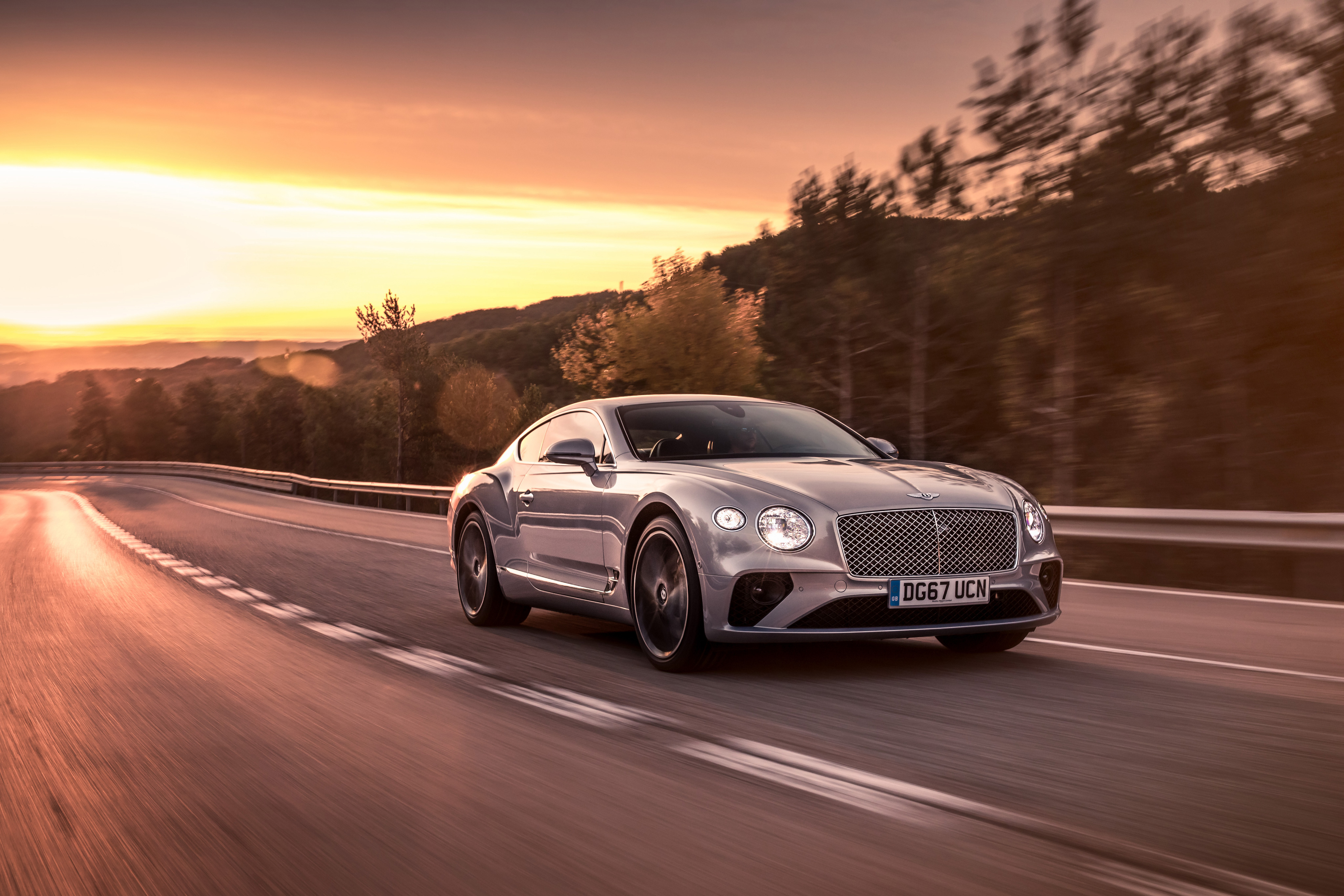 Silver Car Bentley Continental Gt On The Background Of Sunset