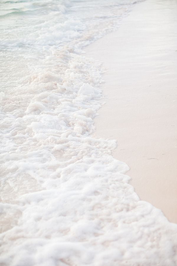 Two People Walking On The Beach With Surfboards Wallpaper
