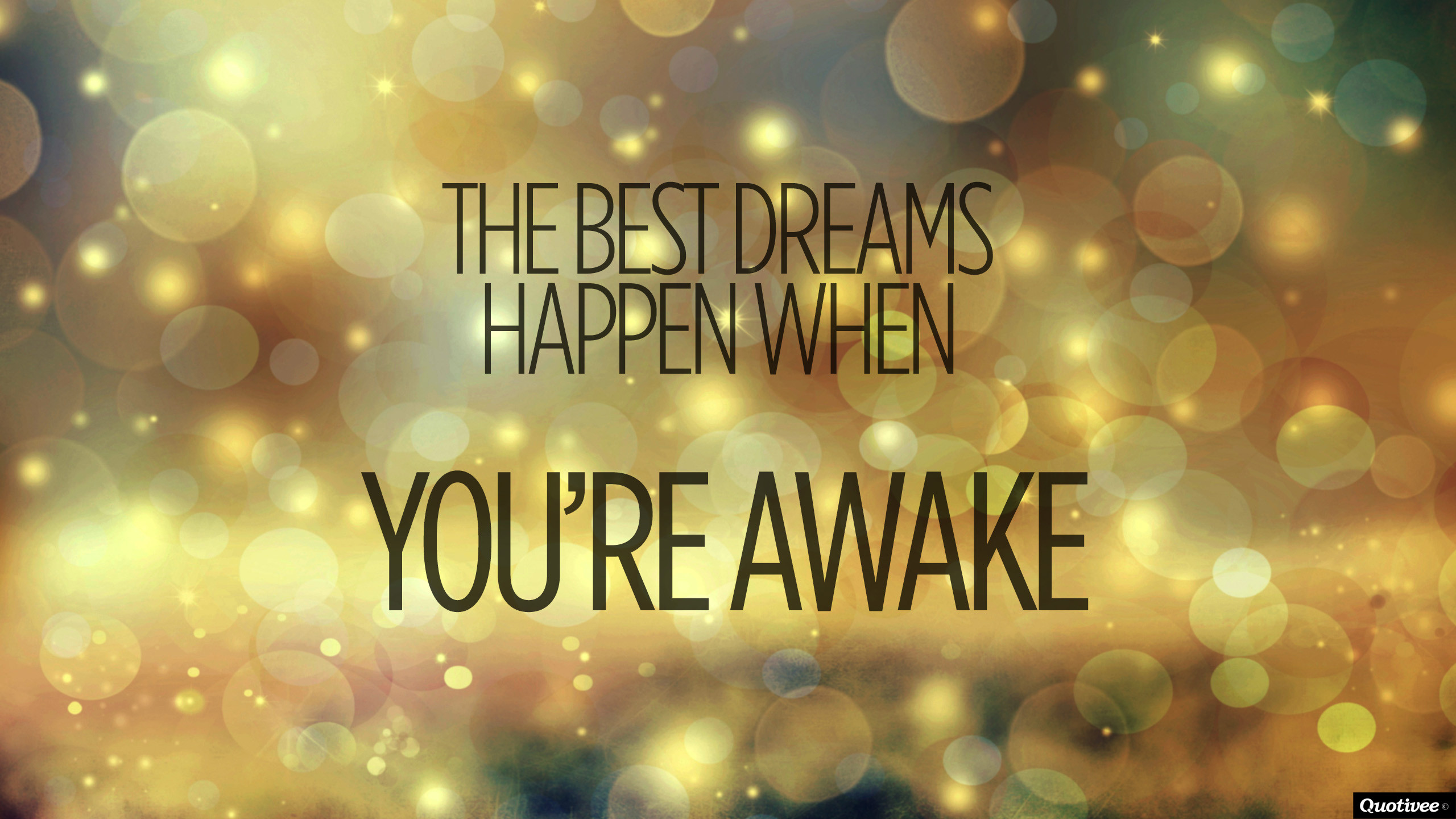 A motivational quote on a sparkling bokeh background: 'The best dreams happen when you're awake.'
