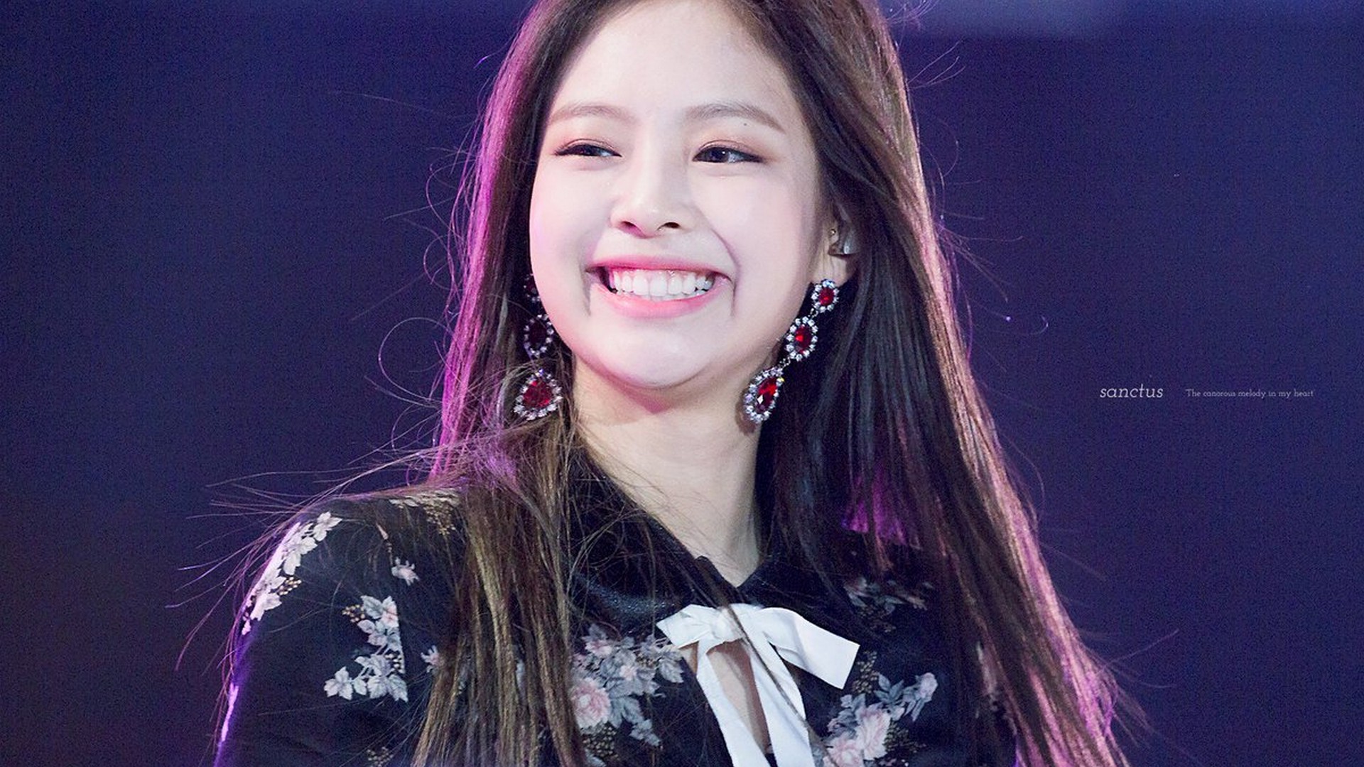 Jennie Kim, South Korean singer and member of Blackpink, smiling brightly during a performance
