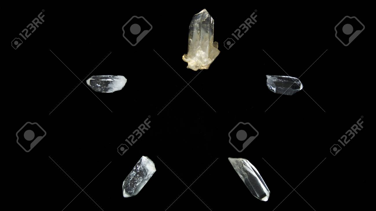 Five Clear Quartz Crystal Points On Black Background Forming