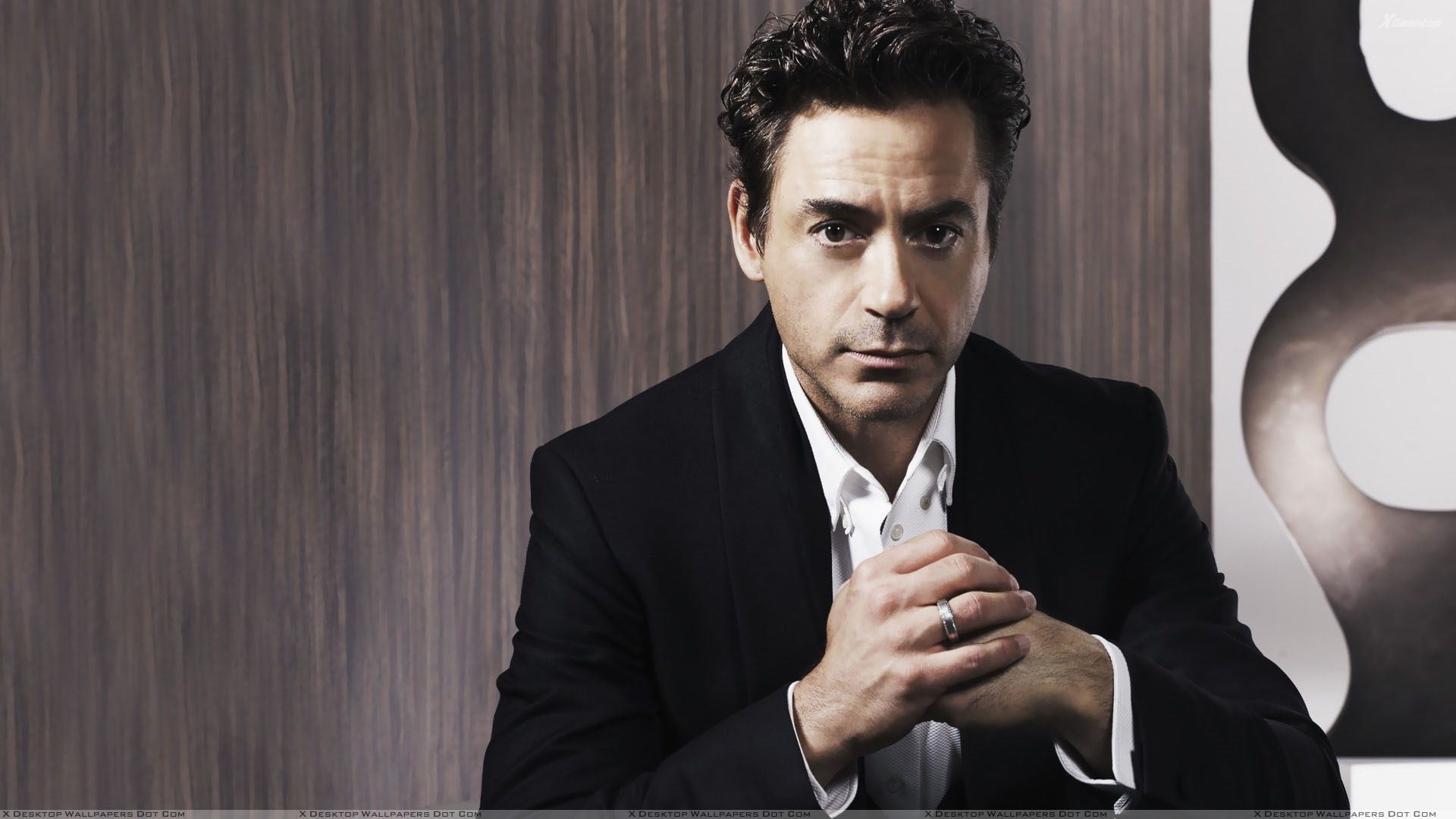 Robert Downey Jr Sitting Pose In Black Coat Wallpaper