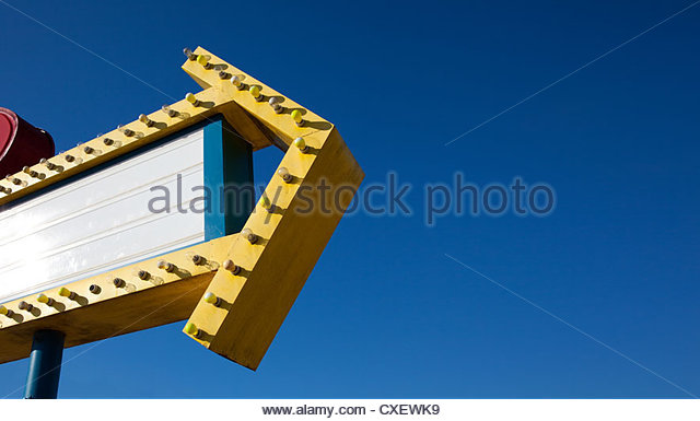 Retro Drive In Theater Neon Sign With A Blue Sky Background Stock