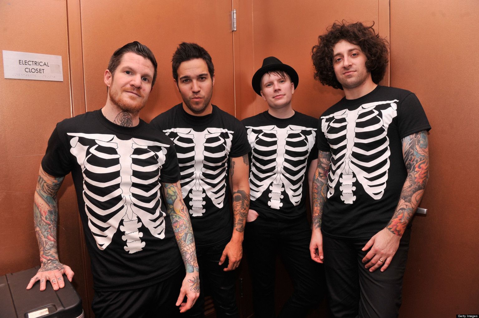 Fall Out Boy band members wearing skeleton shirts, posing for a photo