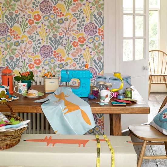 Colourful Wallpaper Behind Table With Blue Sewing Machine And