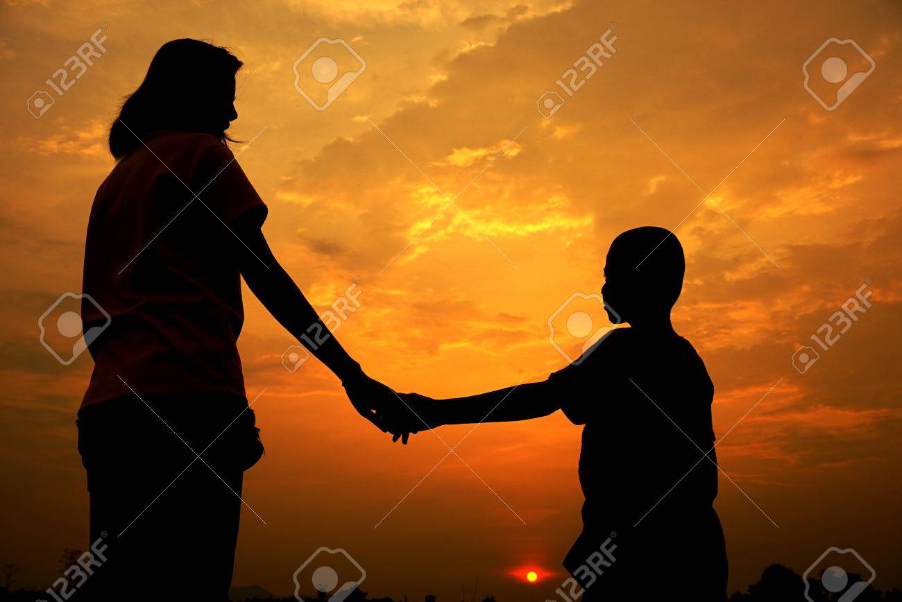 Mother And Son Holding Hand In Sunset Day Background Stock