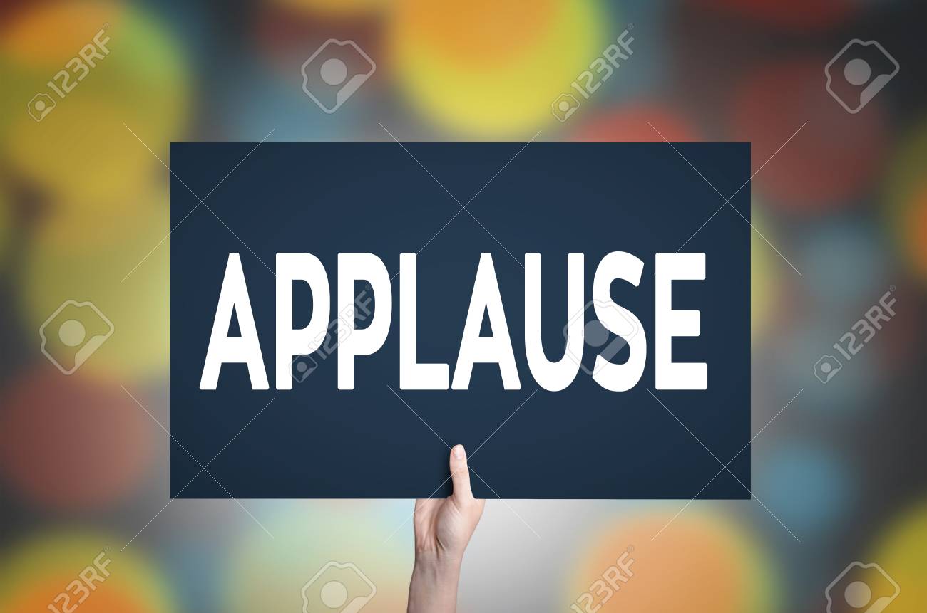 Applause Card In Hand With Bokeh Lights Background Stock Photo