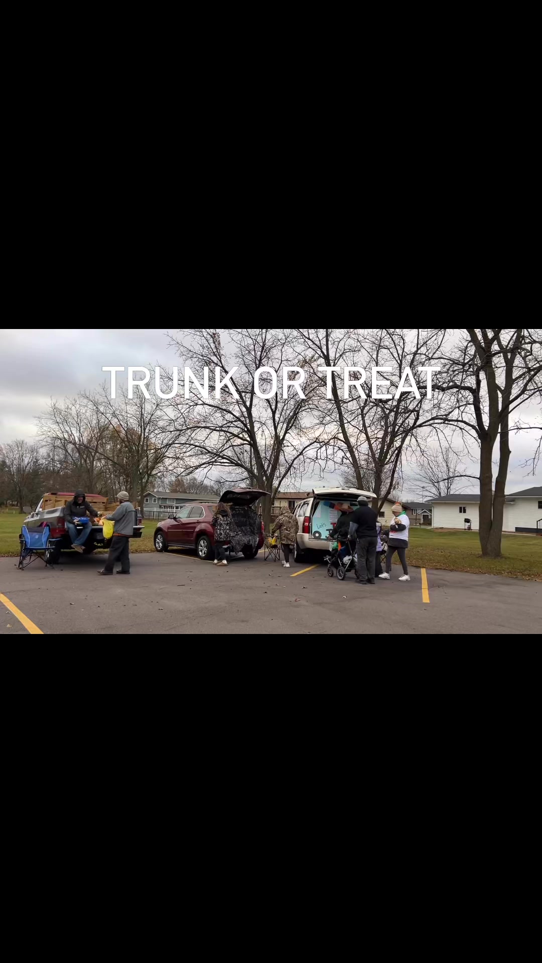 People participate in a trunk-or-treat event in a parking lot