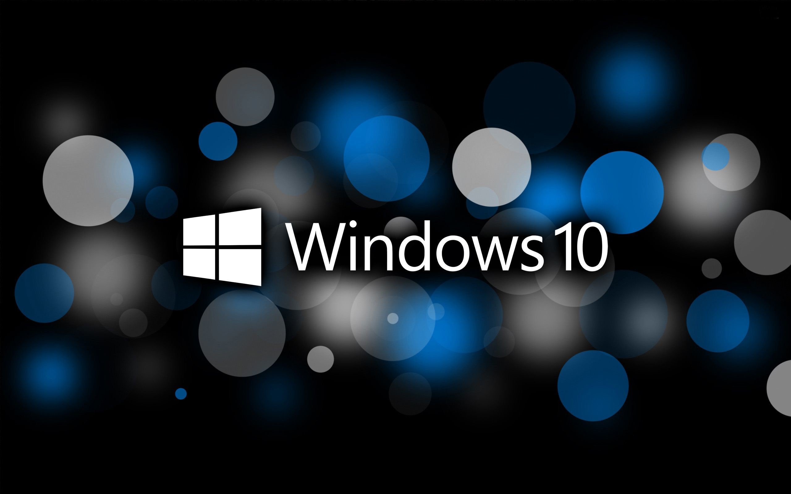 Abstract Windows 10 logo on a dark background with blue and white bokeh circles