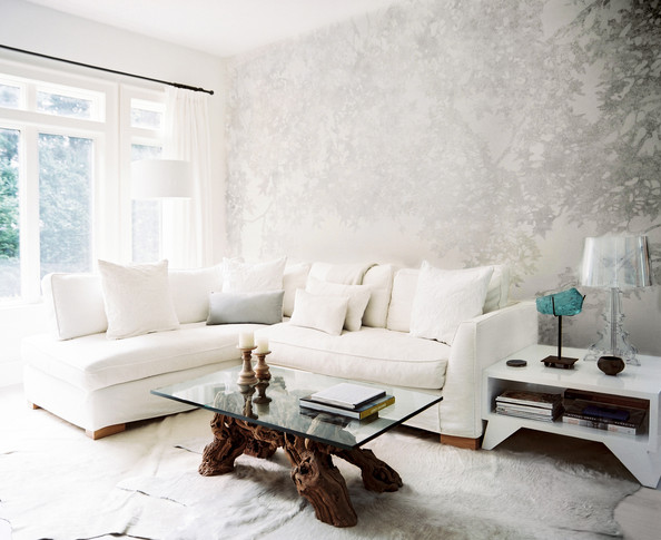 Living Room Nature Inspired Wallpaper Behind A White Sectional Couch