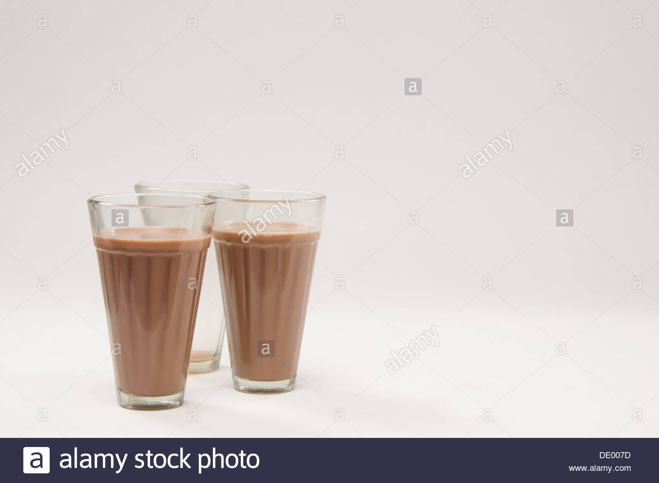 Two Glasses Of Chai With An Empty Glass Isolated Over White Stock