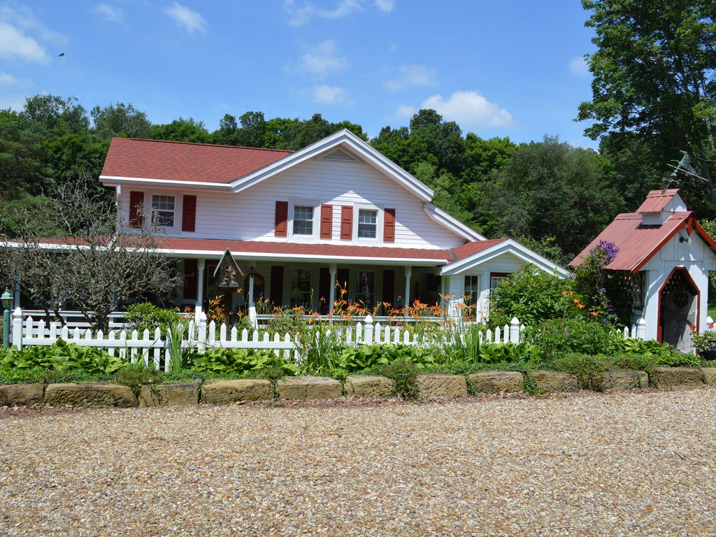 Restored Historical Farmhouse With Pond And Farm Animals At