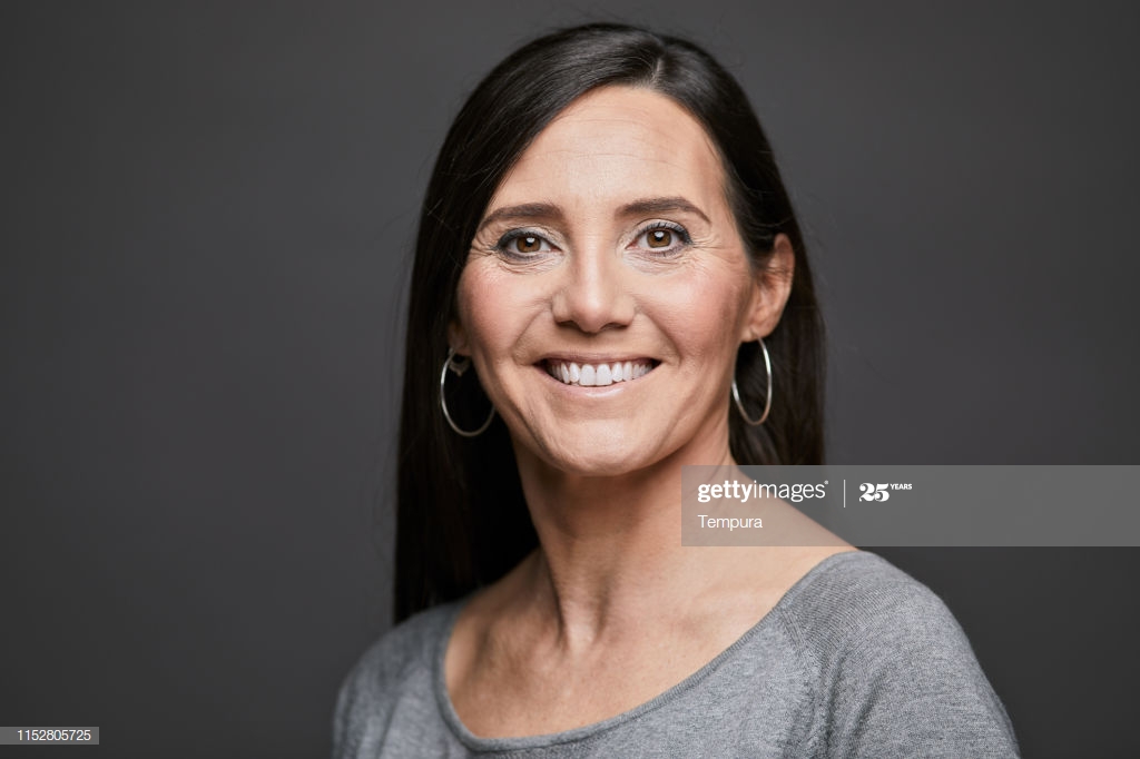Business Headshot Portrait Looking At Camera On Gray Background