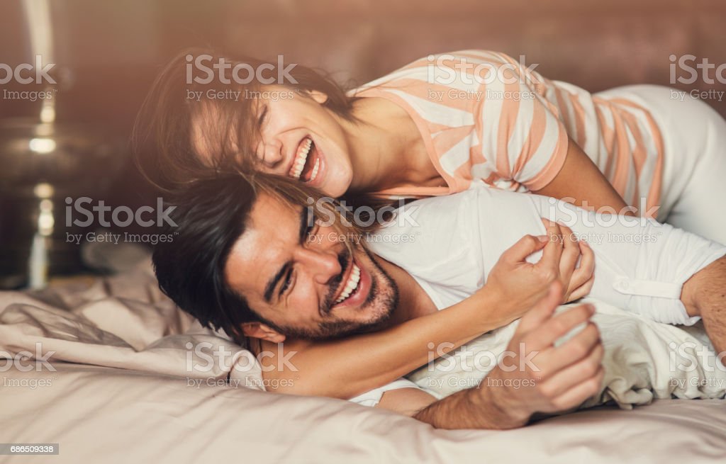 Happy Young Couple In Bed Stock Photo   Download Image Now