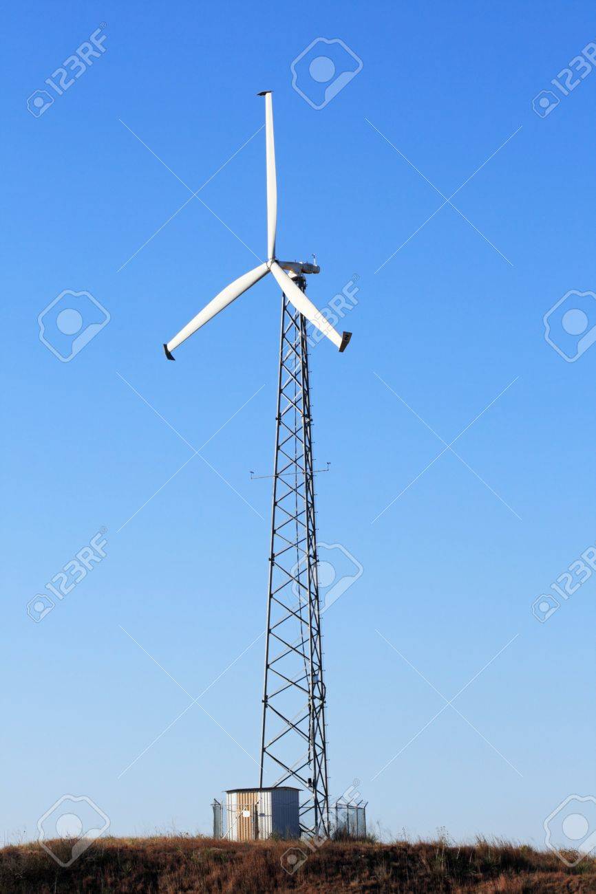 Vertical Image Of Tall Electric Windmill Or Wind Turbine With