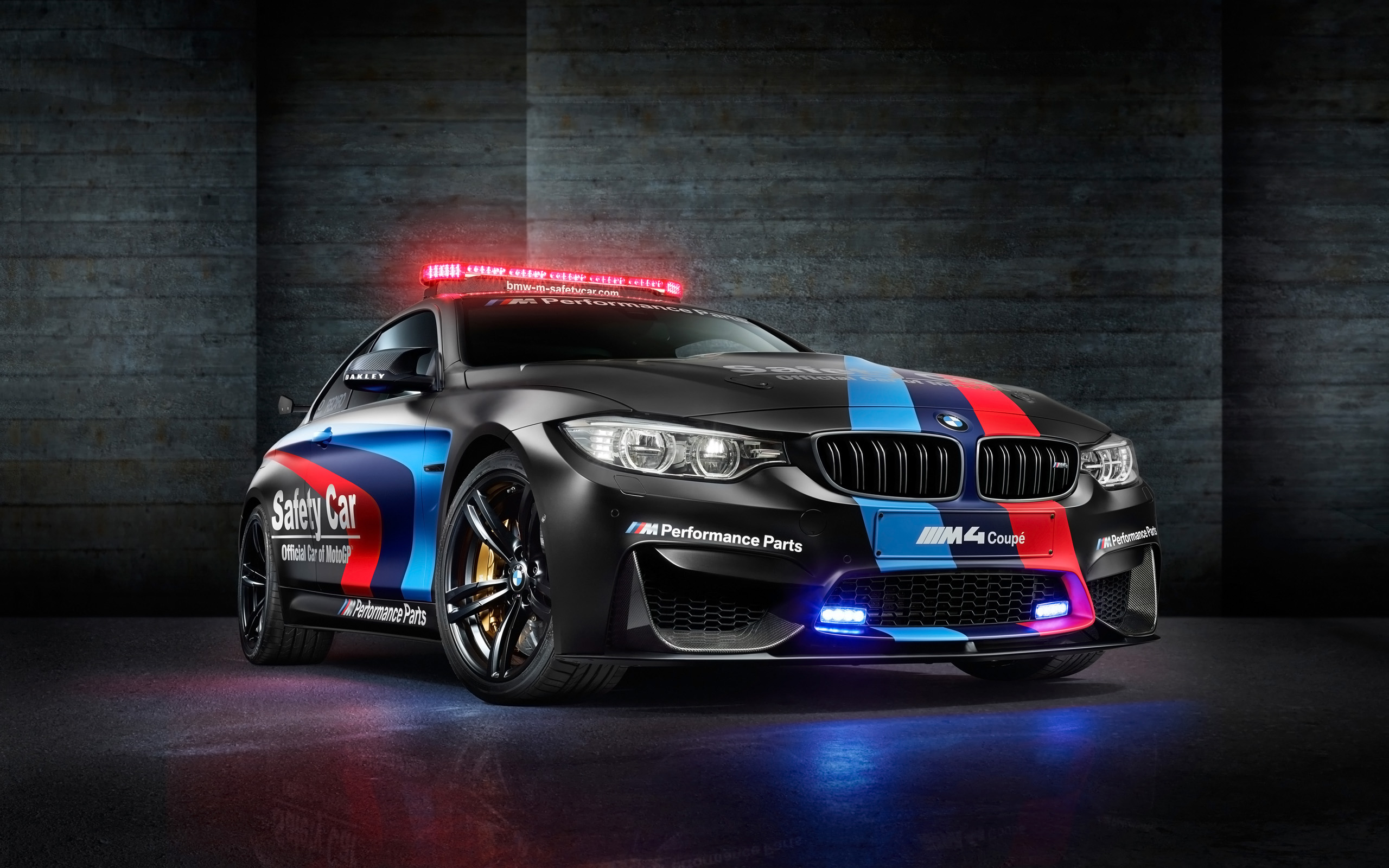BMW M4 Coupe Safety Car in a dimly lit garage