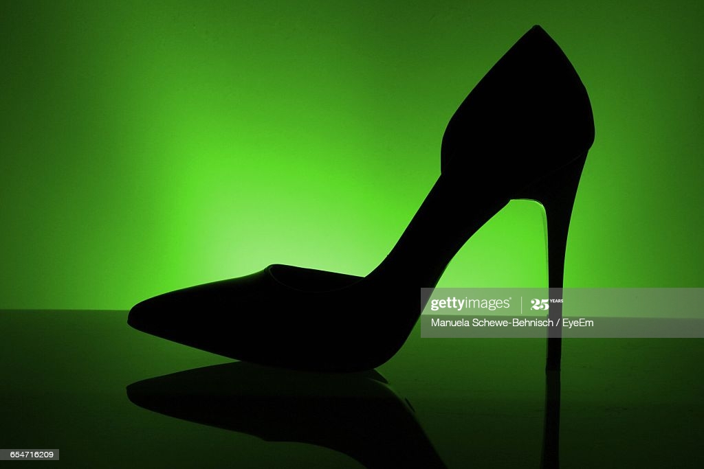 High Heels With Reflection Against Green Background Res Stock