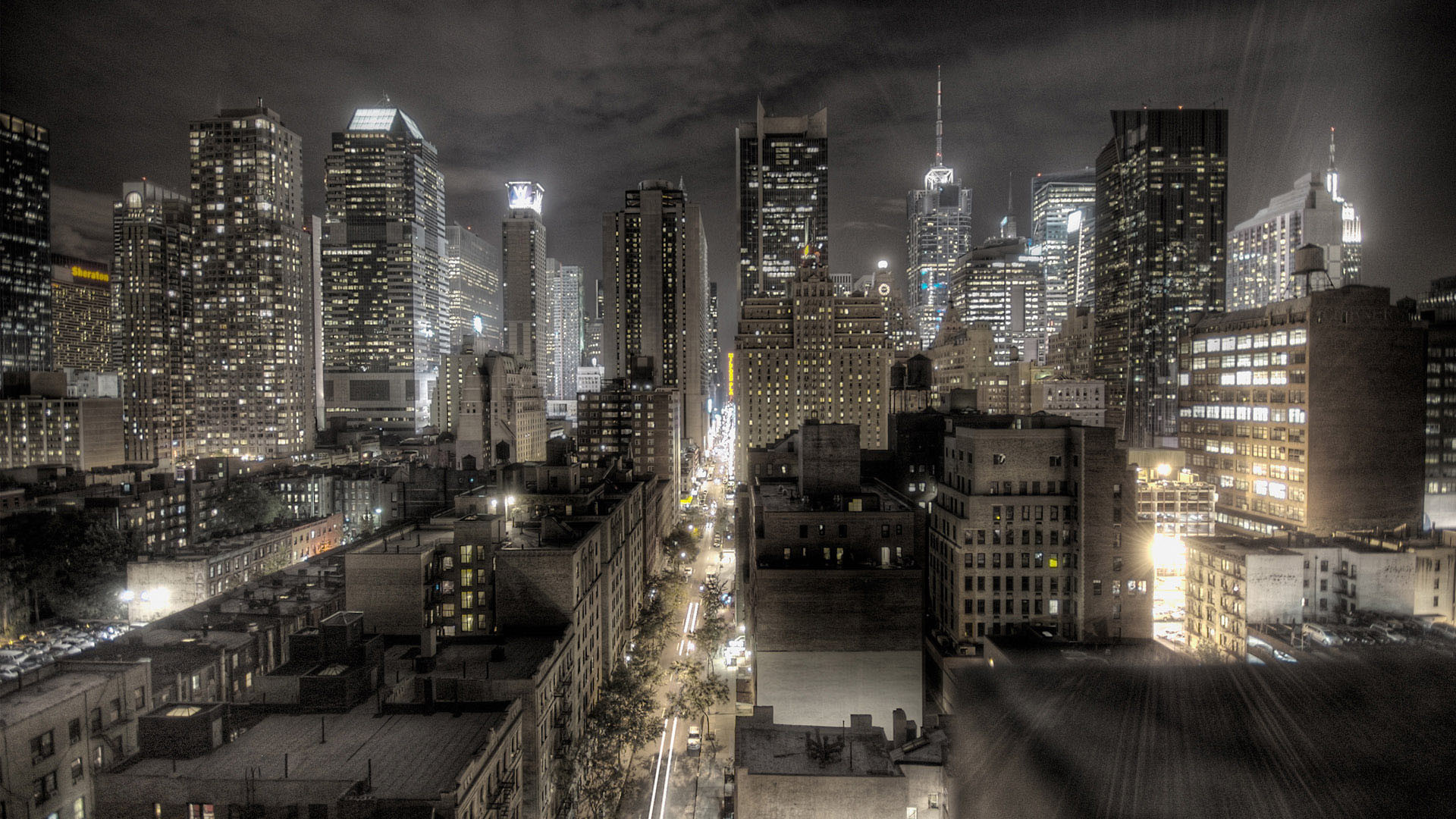 A dramatic nighttime cityscape of New York City, with towering skyscrapers and city lights creating a stunning urban landscape
