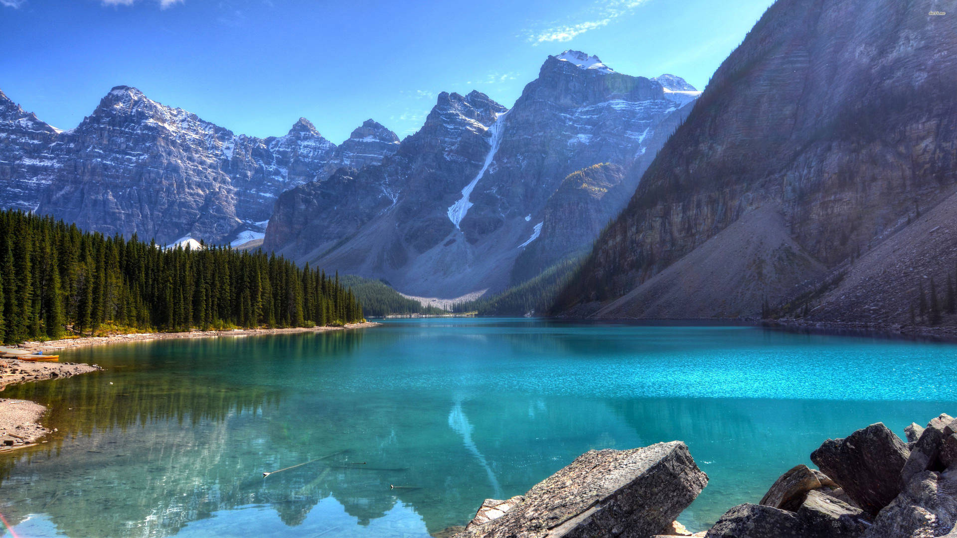 A breathtaking vista of turquoise Moraine Lake nestled amidst the snow-capped Canadian Rockies
