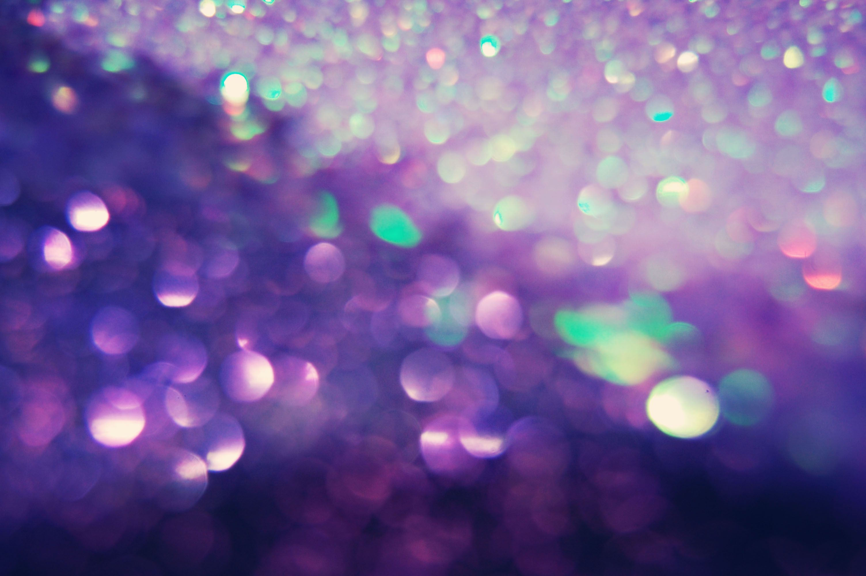 Close-up of shimmering pink glitter with a soft, dreamy bokeh effect