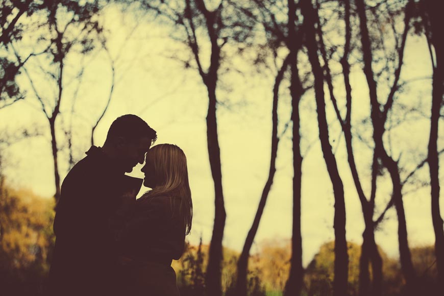 The Happy Couple Embrace With Trees In Background Vanishing