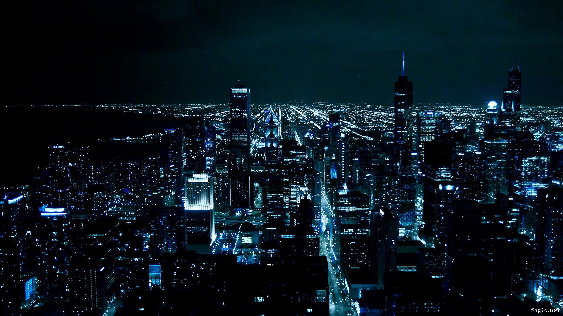 Stunning aerial view of a vibrant cityscape at night, illuminated by lights. The urban landscape stretches into the horizon, creating a breathtaking and captivating night scene