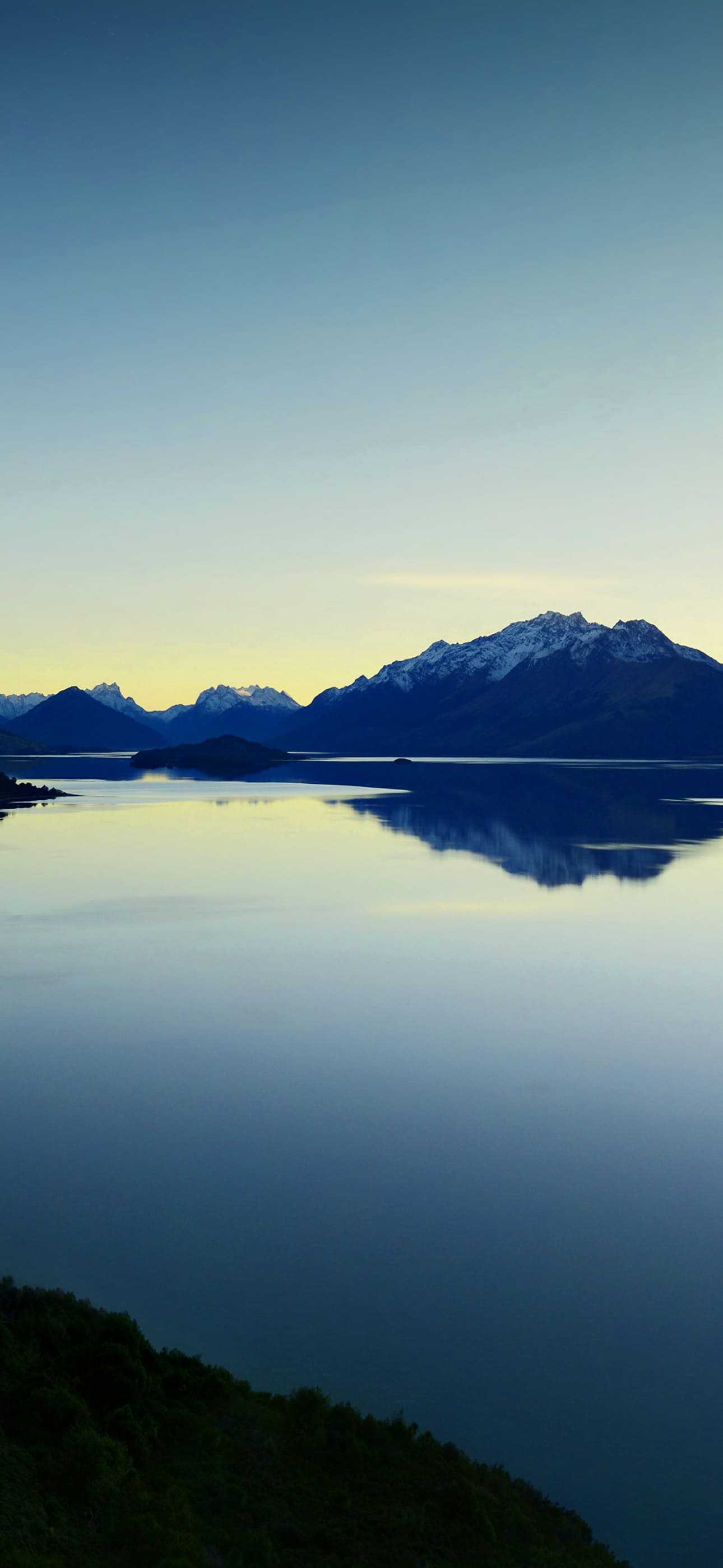 Serene mountain lake landscape at sunset, perfect for an iPhone 14 Pro Max wallpaper