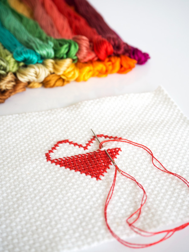 Stitching Red Heart Shape On White Fabric Background