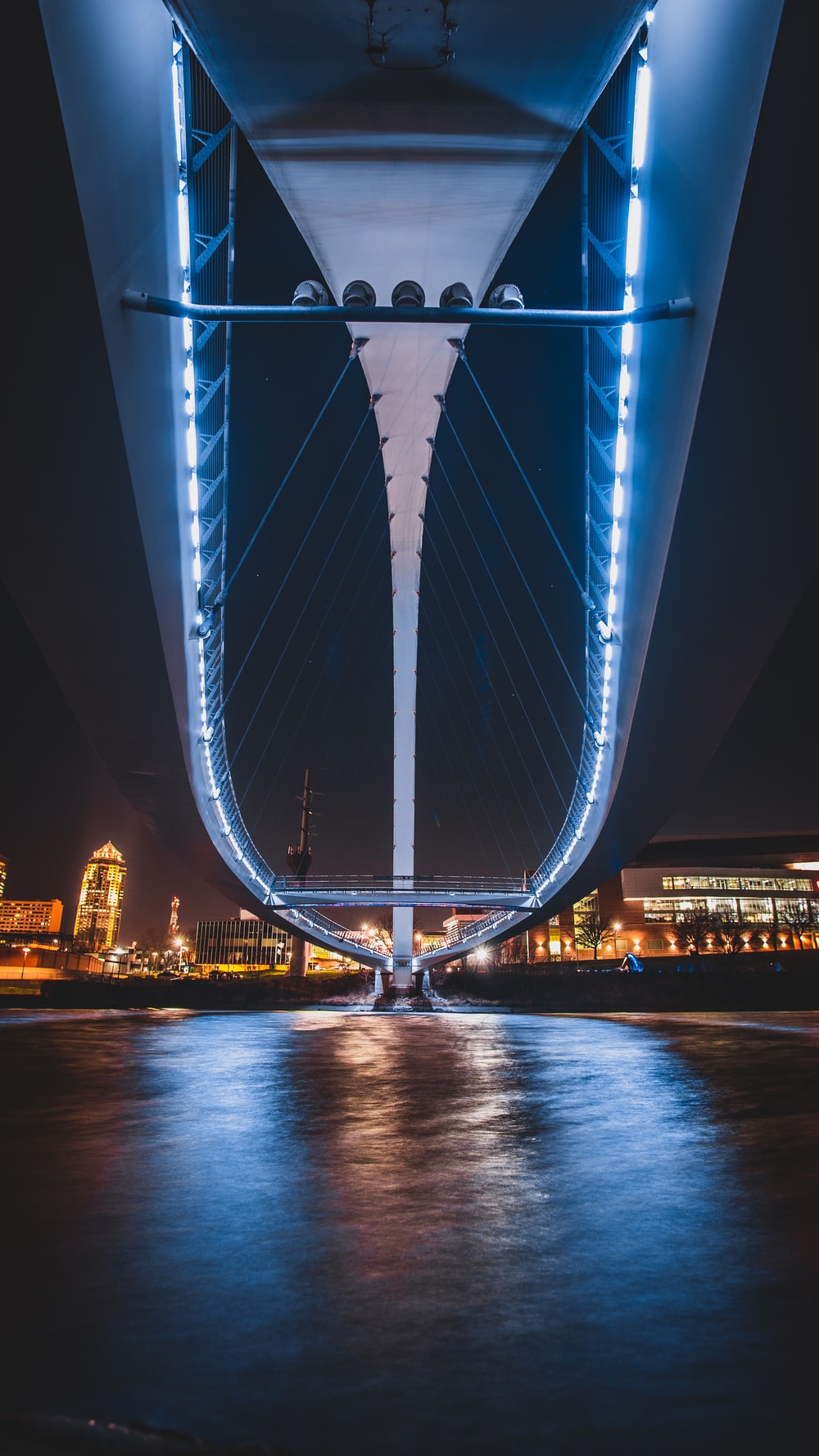 Blue Bridge Over Body Of Water During Night Time Photo Des