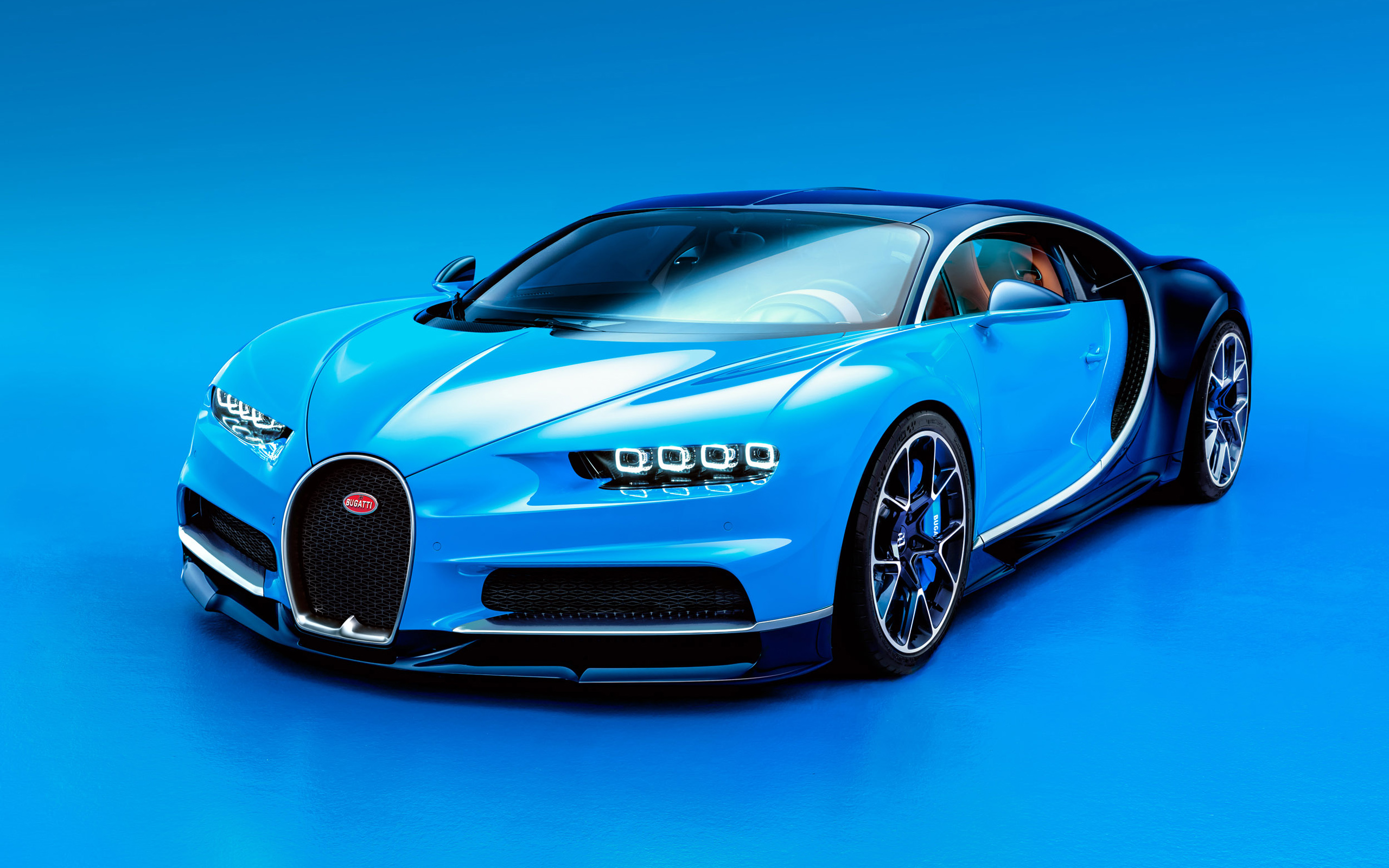 A stunning Bugatti Chiron sports car in vibrant blue, set against a matching backdrop